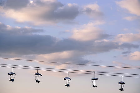 silhouette of five skilift under cloudy sky thumbnail