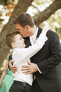 man kissing boy on forehead thumbnail