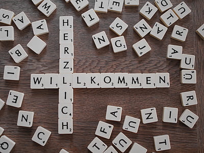 scrabble chips on brown wooden surface thumbnail