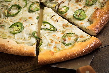 sliced pizza on brown wooden surface thumbnail