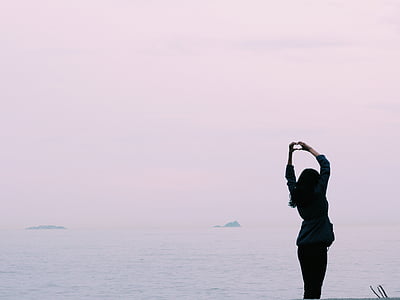 woman doing heart hand sign thumbnail