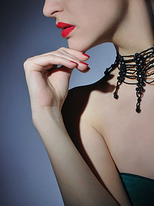 woman wearing black necklace and top thumbnail
