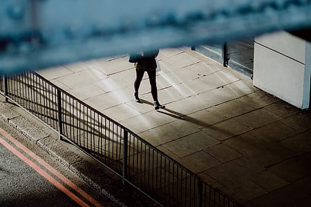 person walking on gray concrete pavement thumbnail