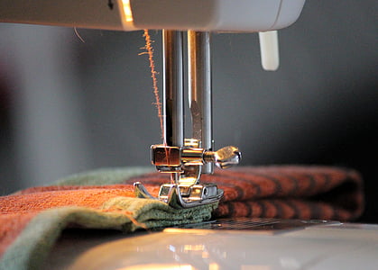 brown and green textile on sewing machine thumbnail