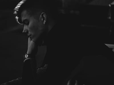 grayscale photograph of man in long-sleeved shirt thumbnail