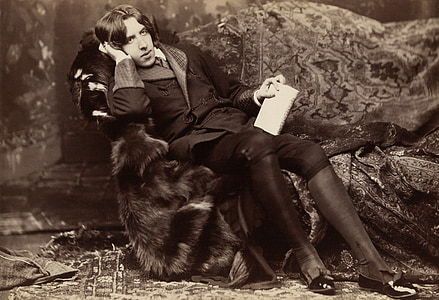 man wearing double-breasted coat sitting on sofa chair photography thumbnail