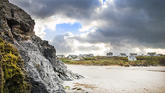 White Sand Beside Grey Rock Cliff thumbnail