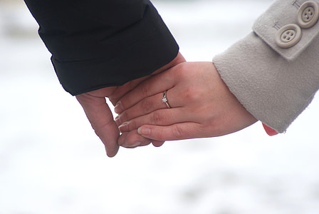 two persons holding hands during daytime thumbnail