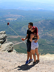 man and woman taking selfie thumbnail