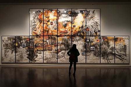 silhouette of woman in front of wall painting thumbnail