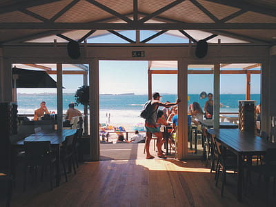 people inside restaurant beside sea thumbnail