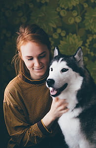 Woman Holding Adult Siberian Husky thumbnail