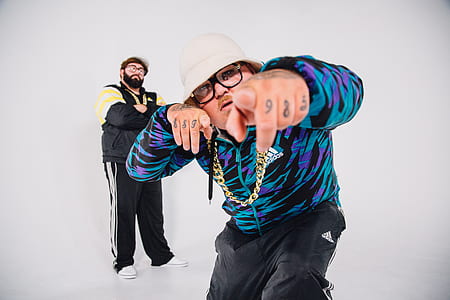 two man wearing black adidas pants thumbnail
