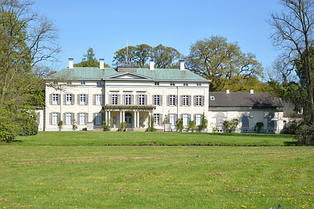 white and green concrete building surrounded with green trees at daytime thumbnail