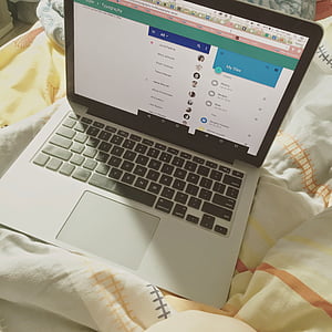 turned-on MacBook Pro on white textile thumbnail