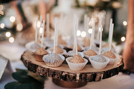 selective focus photography of lolipop cupcakes served thumbnail