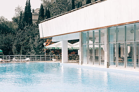 White and Gray Concrete Building Near Blue Swimming Pool thumbnail