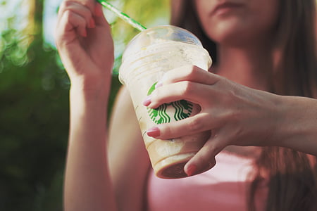 woman holding Starbucks cup thumbnail