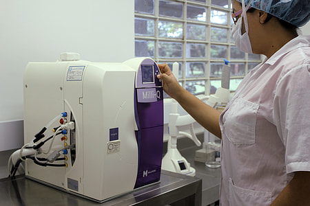 woman pressing button on machine thumbnail