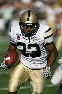 male football player carrying football thumbnail