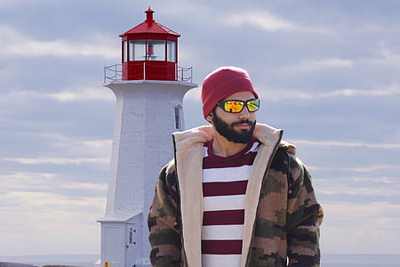 man standing near lighthouse thumbnail