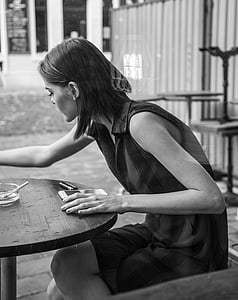 woman sitting down on chair while having a cigarette thumbnail