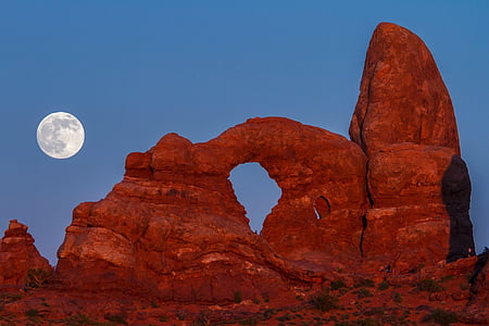 brown rock formation and moon photo thumbnail