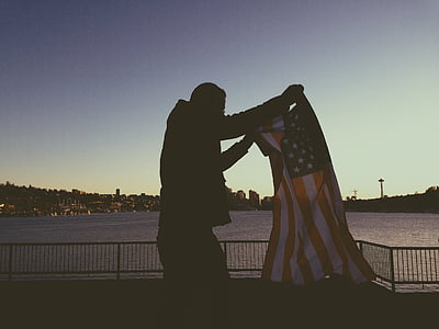 man holding flag of America thumbnail