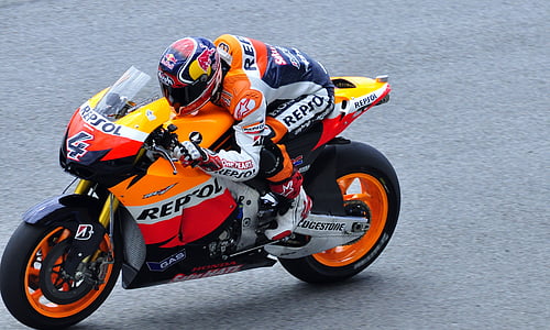 person driving Honda CBR repsol edition sports bike during daytime thumbnail