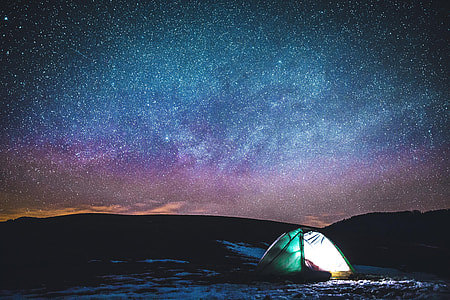 Camping in tent under the stars in the night sky thumbnail