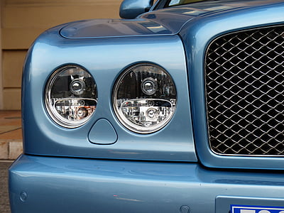 blue car near brown painted wall thumbnail