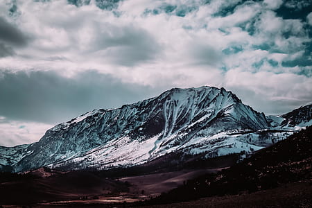 snow covered mountain under cloudy sky thumbnail