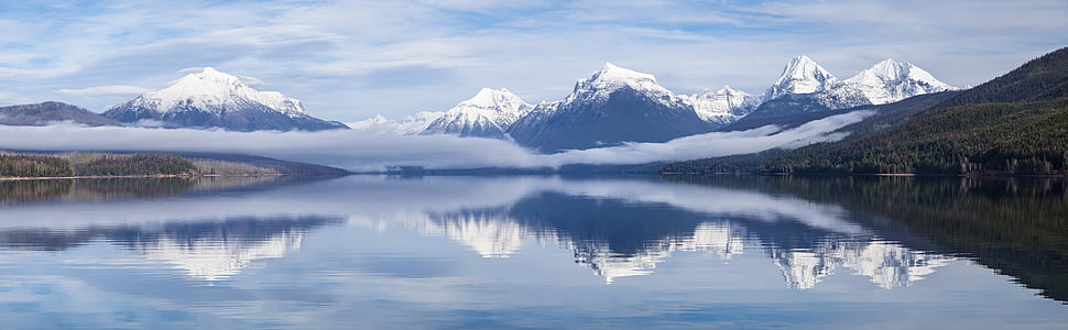 snow capped mountain mirror on lake during daytime thumbnail