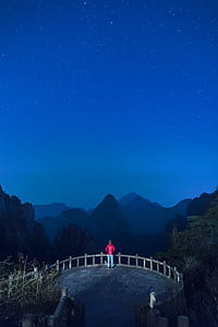 man on mountain during night time thumbnail