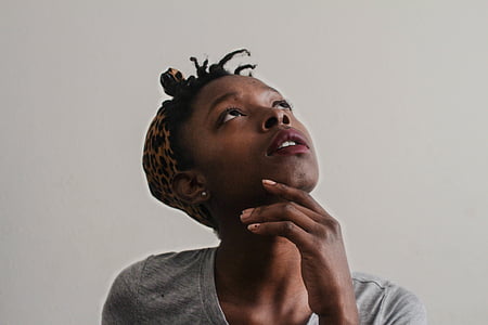 woman wearing heather grey crew-neck top while looking up thumbnail
