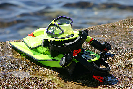 green snorkel gear on concrete by the sea thumbnail