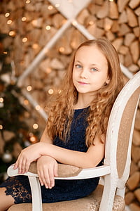girl sitting on white and brown chair taking a selfie thumbnail