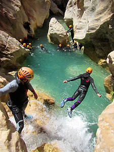 person wearing black and purple wetsuit jumping thumbnail