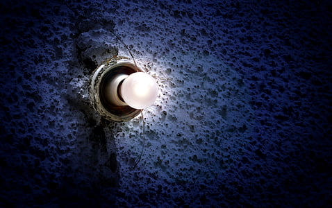 white lightbulb on white concrete wall thumbnail