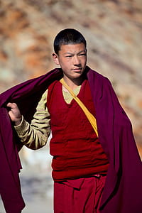 man standing holding purple shawl thumbnail