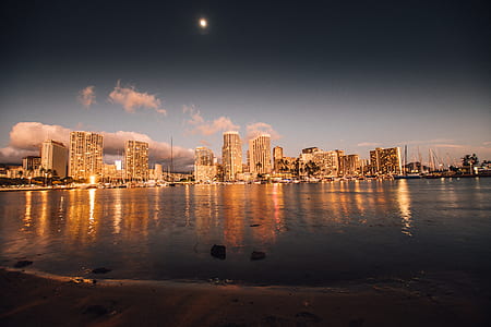 city buildings near ocean under blue sky during daytime thumbnail