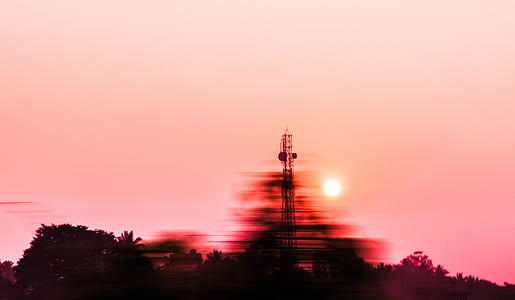 silhouette of signal tower beside trees thumbnail