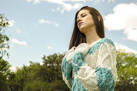 Woman in White and Teal Crochet Dress Under Cloudy Sky thumbnail