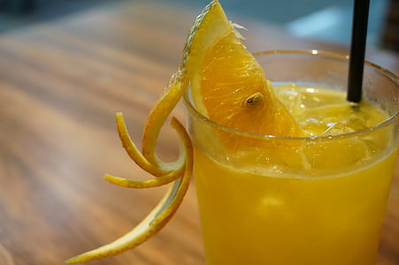 shallow focus photography of drinking glass with juice and sliced lemon thumbnail