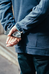 person holding black framed Ray-Ban Wayfarer sunglasses thumbnail