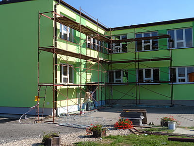 green concrete building beside scaffolding thumbnail