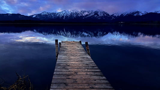 low light photography of wooden dock near body of water thumbnail