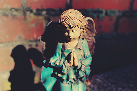 photography of brown-haired angel ceramic figurine thumbnail