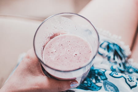 Person Holding Clear Drinking Glass With Fruit Shake Close-up Photo thumbnail
