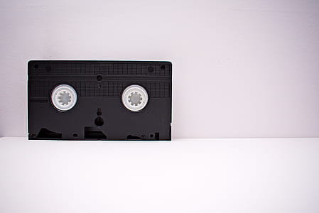 Black And White Vhs Tape On White Wooden Surface thumbnail